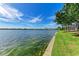 Picturesque lake view highlights waterfront homes, clear skies, and verdant lawns at 138 Toscavilla Blvd, Nokomis, FL 34275
