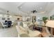 Spacious living room with tile flooring, comfortable seating, and an open floor plan at 138 Toscavilla Blvd, Nokomis, FL 34275