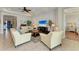 Bright living room featuring tile floors, textured wall, and modern furnishings at 138 Toscavilla Blvd, Nokomis, FL 34275