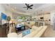 Inviting living room featuring an open floor plan, tile floors, and a scenic lake view at 138 Toscavilla Blvd, Nokomis, FL 34275