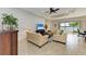 Open-concept living room with textured wall, tile floors, and water views at 138 Toscavilla Blvd, Nokomis, FL 34275