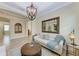 Well-lit formal living area with large mirror, chandelier and tile floors at 138 Toscavilla Blvd, Nokomis, FL 34275
