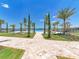 Expansive pool area with lounge chairs, landscaping, and lake views in a resort-style setting at 138 Toscavilla Blvd, Nokomis, FL 34275
