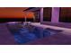 An inviting pool with lounge chairs, a spa, and ambient lighting, perfect for relaxation at 138 Toscavilla Blvd, Nokomis, FL 34275
