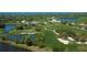 Picturesque aerial view of the golf course and surrounding community at 140 Sugar Mill Dr, Osprey, FL 34229