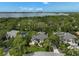 Stunning aerial view of a luxury home surrounded by lush landscaping and a bay in the distance at 140 Sugar Mill Dr, Osprey, FL 34229