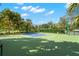 An outdoor basketball court surrounded by lush greenery, perfect for recreation and sports activities within the community at 140 Sugar Mill Dr, Osprey, FL 34229