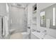Bathroom featuring tiled shower with seat, toilet, and modern sink with shelving and decorative accents at 140 Sugar Mill Dr, Osprey, FL 34229