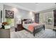 The main bedroom has a dark wood bed frame, ensuite bath access and French doors to the outside at 140 Sugar Mill Dr, Osprey, FL 34229