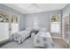 Bright bedroom with two twin beds, large windows, light blue walls, and access to a connected bath at 140 Sugar Mill Dr, Osprey, FL 34229