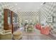 Well-lit dining room with stylish wallpaper, elegant furnishings, and a view to the pool at 140 Sugar Mill Dr, Osprey, FL 34229