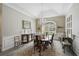 Dining area featuring vaulted ceilings, crown molding, and a decorative chandelier at 140 Sugar Mill Dr, Osprey, FL 34229