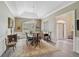 Formal dining room with elegant chandelier, crown molding, and neutral color palette at 140 Sugar Mill Dr, Osprey, FL 34229