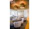 A stylish dining room with modern chandeliers, wine cellar, and comfortable seating at 140 Sugar Mill Dr, Osprey, FL 34229
