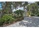 Charming yellow home featuring a two-car garage and lush landscaping at 140 Sugar Mill Dr, Osprey, FL 34229