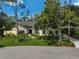 Attractive single-story home with a manicured lawn and colorful garden at 140 Sugar Mill Dr, Osprey, FL 34229