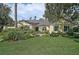Inviting home with a lush front lawn and colorful landscaping creating curb appeal at 140 Sugar Mill Dr, Osprey, FL 34229