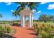 Picturesque gazebo in manicured garden setting next to the golf course and palm trees at 140 Sugar Mill Dr, Osprey, FL 34229