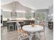 A large open kitchen with white countertops, gray cabinets, and a dining area at 140 Sugar Mill Dr, Osprey, FL 34229