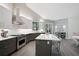 A modern kitchen with stainless steel appliances, a large island, and gray cabinets at 140 Sugar Mill Dr, Osprey, FL 34229