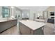 A large kitchen island with white countertop complements gray cabinets and stainless steel appliances at 140 Sugar Mill Dr, Osprey, FL 34229