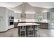 Modern kitchen with stainless steel appliances, island seating, and sleek cabinetry at 140 Sugar Mill Dr, Osprey, FL 34229