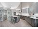 A large kitchen with stainless steel appliances, gray cabinets, and a large island at 140 Sugar Mill Dr, Osprey, FL 34229