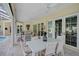 Outdoor covered patio with ample seating, dining table, and views of the beautiful pool and backyard at 140 Sugar Mill Dr, Osprey, FL 34229