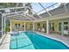 Stunning screened-in pool and spa area, perfect for relaxation and entertainment, with easy access to patio at 140 Sugar Mill Dr, Osprey, FL 34229