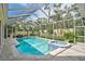 Beautiful screened-in pool and spa with lush landscaping providing privacy and a relaxing atmosphere at 140 Sugar Mill Dr, Osprey, FL 34229