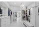 Spacious walk-in closet with custom shelving, chandelier, drawers and ample storage for an organized wardrobe at 140 Sugar Mill Dr, Osprey, FL 34229