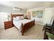 Bedroom featuring wood-look tile floors, an en suite bathroom and coastal decor at 152 Coolidge Dr, Sarasota, FL 34236