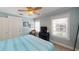 Comfortable bedroom with a ceiling fan and light blue accent wall and two windows at 152 Coolidge Dr, Sarasota, FL 34236