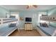 Spacious bunk room with four beds, wood look tile floor and flat screen TV at 152 Coolidge Dr, Sarasota, FL 34236