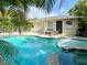 Inviting pool and spa surrounded by lush landscaping create a private backyard retreat at 152 Coolidge Dr, Sarasota, FL 34236