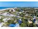 High angle, aerial front view showcasing a charming home surrounded by lush greenery and mature trees near the beach at 160 Coolidge Dr, Sarasota, FL 34236