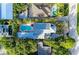 Private backyard with sparkling pool, lush landscaping, and a tranquil outdoor space, seen from above at 160 Coolidge Dr, Sarasota, FL 34236