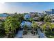 Aerial front view showcasing a charming home surrounded by lush greenery and mature trees in a coastal neighborhood at 160 Coolidge Dr, Sarasota, FL 34236