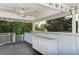 Spacious covered outdoor deck with weathered wood decking, cabinets, and white ceiling, offering a relaxing retreat at 160 Coolidge Dr, Sarasota, FL 34236