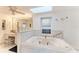 Bright bathroom features a skylight, vanity, and a luxurious tiled tub at 160 Coolidge Dr, Sarasota, FL 34236