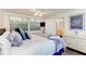 Cozy bedroom with ceiling fan, ensuite bath, and a bright, sunny window at 160 Coolidge Dr, Sarasota, FL 34236