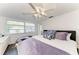 Inviting bedroom with ceiling fan, dark hardwood floors, and a bright sunny window at 160 Coolidge Dr, Sarasota, FL 34236