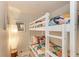 Cozy bedroom with bunkbeds and a decorative lamp on white marble tile flooring at 160 Coolidge Dr, Sarasota, FL 34236