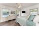 Bright bedroom featuring a ceiling fan, outdoor access and a flat screen television at 160 Coolidge Dr, Sarasota, FL 34236