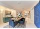 Open concept dining room with views to kitchen, stylish table, and barn door at 160 Coolidge Dr, Sarasota, FL 34236