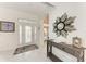 Bright entryway featuring tile flooring, elegant decor, and a decorative glass front door at 160 Coolidge Dr, Sarasota, FL 34236