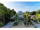 Stunning exterior view of a multi-story home with palm trees, detailed trim, and a charming entrance at 160 Coolidge Dr, Sarasota, FL 34236