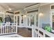 Welcoming front porch with a hanging chair, stylish lighting, and access to the home's entry at 160 Coolidge Dr, Sarasota, FL 34236