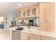 Cozy kitchen features white cabinets, dual basin sink, and stainless steel dishwasher at 160 Coolidge Dr, Sarasota, FL 34236