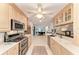Modern kitchen with stainless steel appliances and tile floors seamlessly connecting to the adjacent dining area at 160 Coolidge Dr, Sarasota, FL 34236